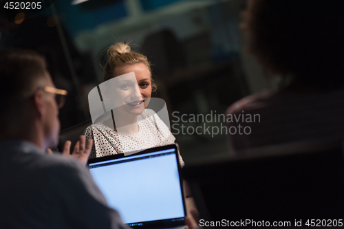 Image of Multiethnic startup business team in night office