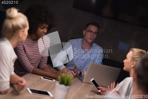 Image of Multiethnic startup business team in night office