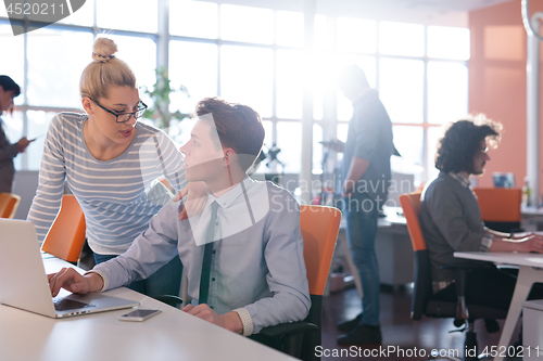 Image of Two Business People Working With laptop in office