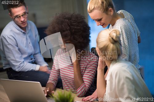 Image of Multiethnic startup business team in night office