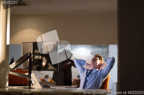 Image of businessman relaxing at the desk