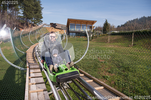 Image of father and son enjoys driving on alpine coaster