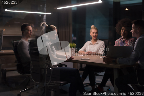 Image of Multiethnic startup business team in night office