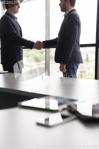 Image of cloasing the deal in modern office interior