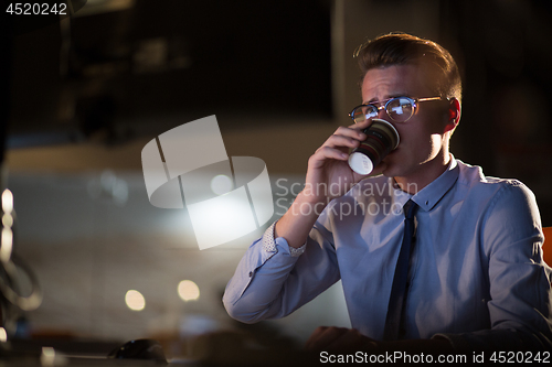 Image of Tired businessman working late