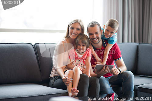 Image of happy young couple spending time with kids