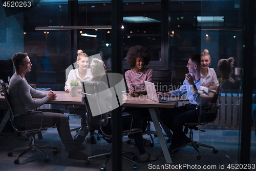 Image of Multiethnic startup business team in night office