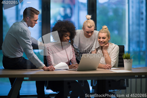 Image of Multiethnic startup business team in night office