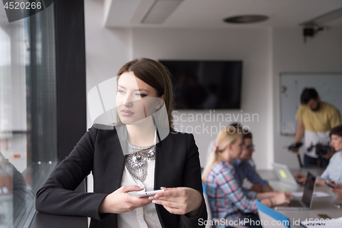 Image of Business Girl Standing In A Modern Building Near The Window With