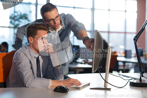 Image of Two Business People Working With computer in office