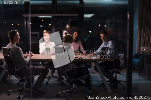 Image of Multiethnic startup business team in night office