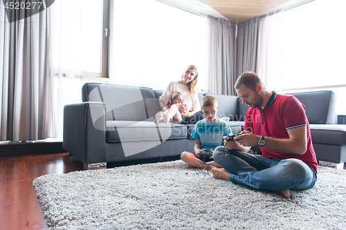 Image of Happy family playing a video game