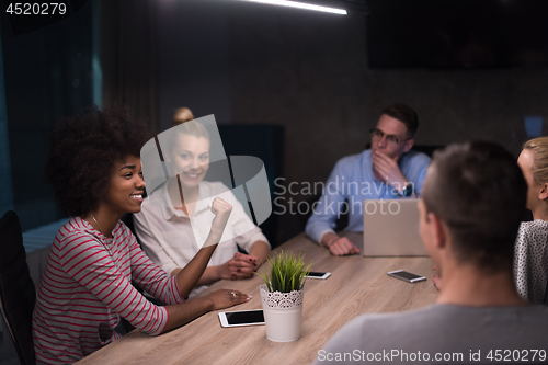 Image of Multiethnic startup business team in night office