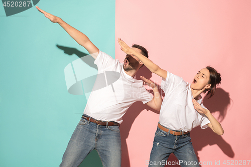 Image of A couple of young man and woman dancing hip-hop at studio.