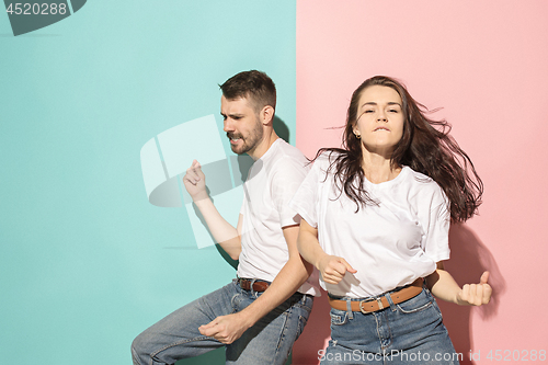 Image of A couple of young man and woman dancing hip-hop at studio.