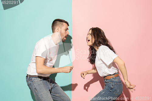 Image of A couple of young man and woman dancing hip-hop at studio.
