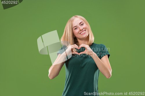 Image of Portrait of attractive cute girl with kiss isolated over green background