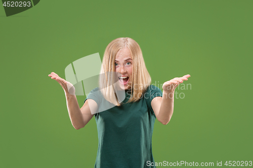Image of Beautiful woman looking suprised isolated on green