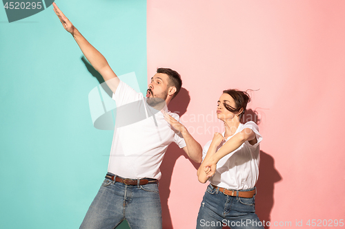 Image of A couple of young man and woman dancing hip-hop at studio.