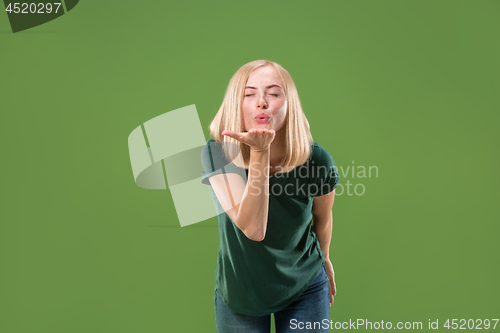 Image of Portrait of attractive cute girl with kiss isolated over green background