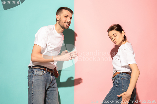 Image of A couple of young man and woman dancing hip-hop at studio.