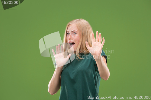 Image of Portrait of the scared woman on green