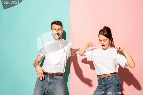 Image of A couple of young man and woman dancing hip-hop at studio.