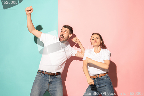 Image of A couple of young man and woman dancing hip-hop at studio.