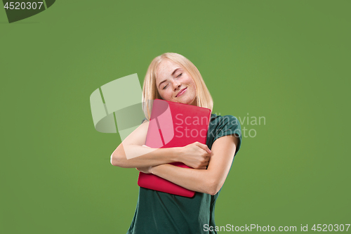 Image of Businesswoman hugging laptop. Love to computer concept. Attractive female half-length front portrait