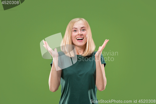 Image of Beautiful woman looking suprised isolated on green