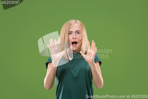 Image of Portrait of the scared woman on green