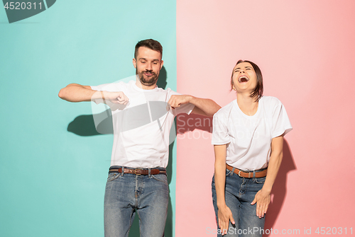 Image of A couple of young man and woman dancing hip-hop at studio.