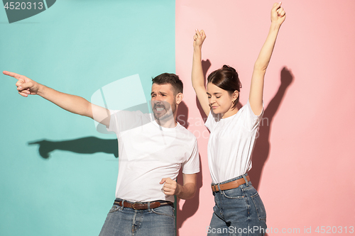 Image of A couple of young man and woman dancing hip-hop at studio.