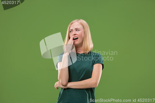 Image of Beautiful bored woman bored isolated on green background