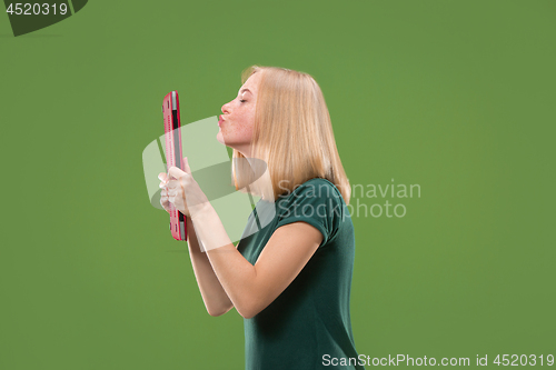 Image of Businesswoman hugging laptop. Love to computer concept. Attractive female half-length front portrait