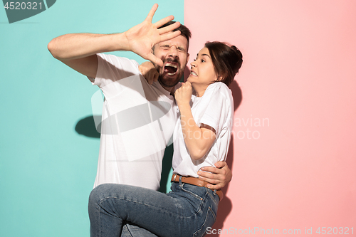 Image of Portrait of the scared man and woman on pink and blue