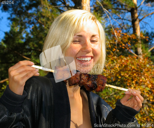 Image of Smiling girl with shashlik