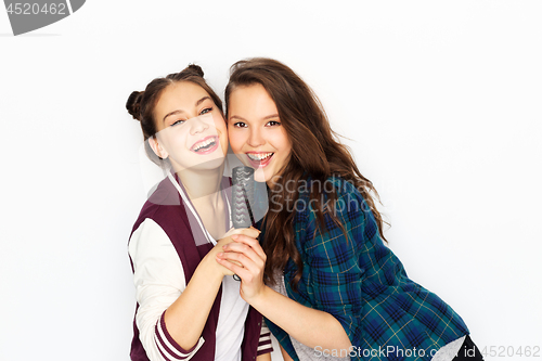 Image of teenage girls singing to hairbrush and having fun