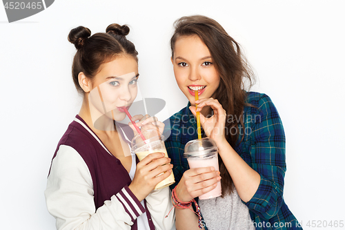 Image of happy teenage girls drinking milk shakes