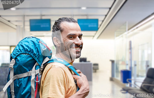 Image of man with backpack over airport terminal