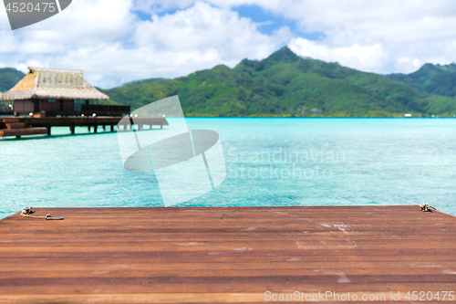 Image of wooden pier and bongalow in french polynesia