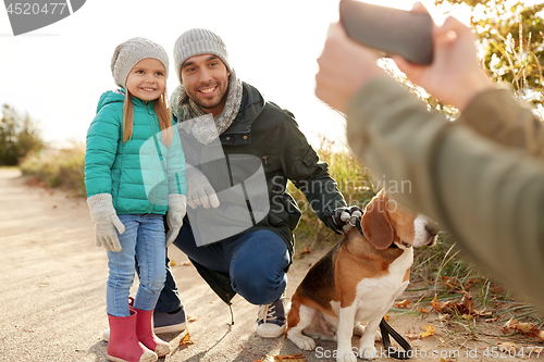 Image of family with dog photographing by smartphone