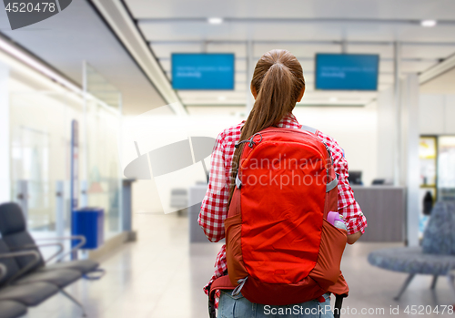 Image of young woman with backpack over airport terminal