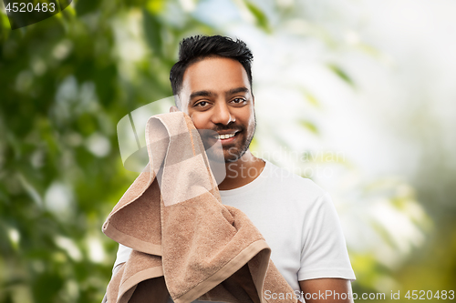 Image of indian man with towel over natural background