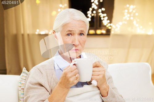 Image of unhealthy senior woman drinking tea on christmas