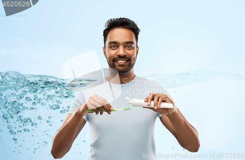 Image of indian man with toothbrush and toothpaste
