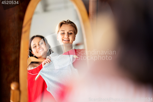 Image of women choosing clothes at vintage clothing store