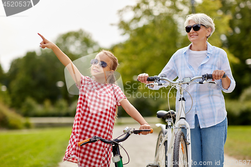 Image of grandmother and granddaughter with bicycles