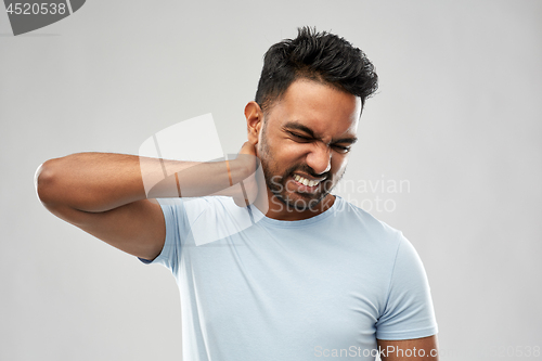 Image of unhealthy indian man suffering from neck pain