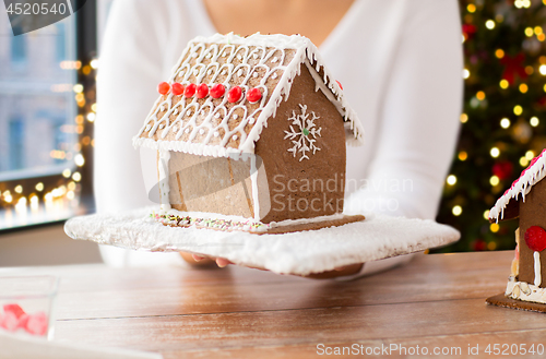 Image of close up of woman with christmas gingerbread house